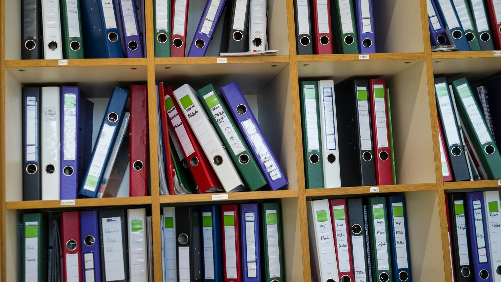 Shelves filled with colorful binders and organized project folders.